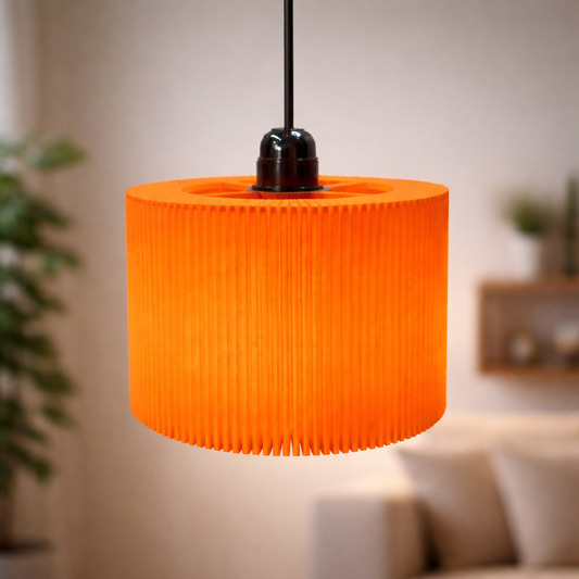 Orange pendant lamp hanging in a room with blurred background