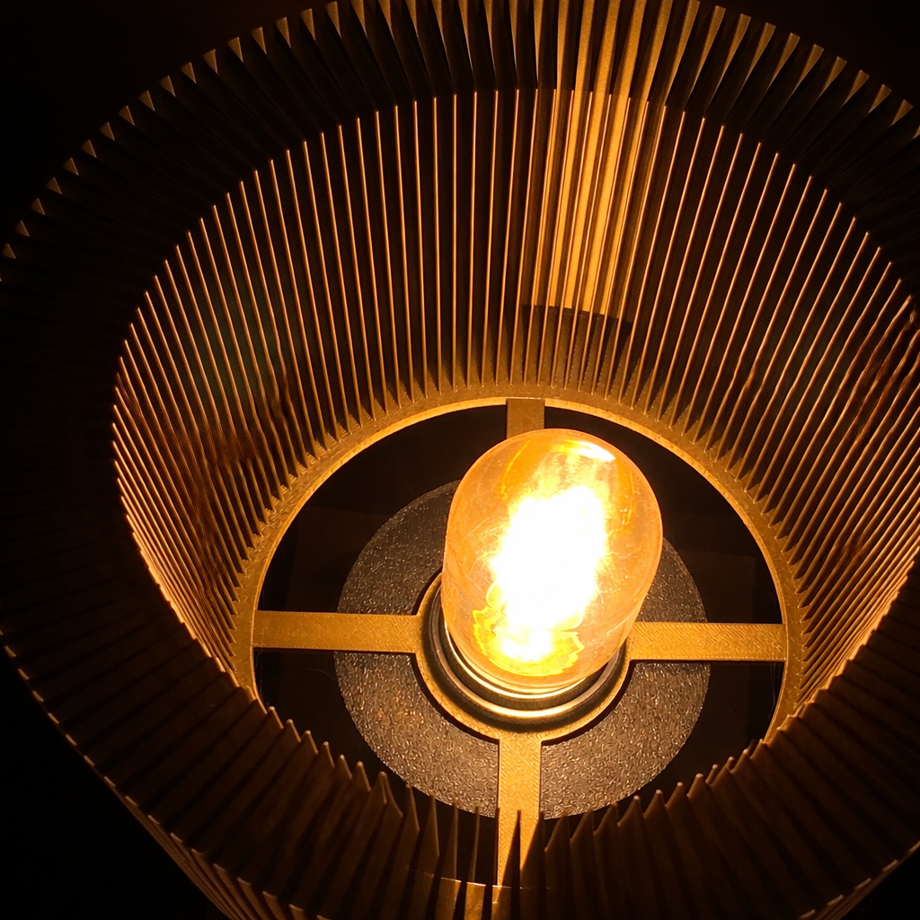 Close-up of a light bulb inside a decorative lampshade with a dark background