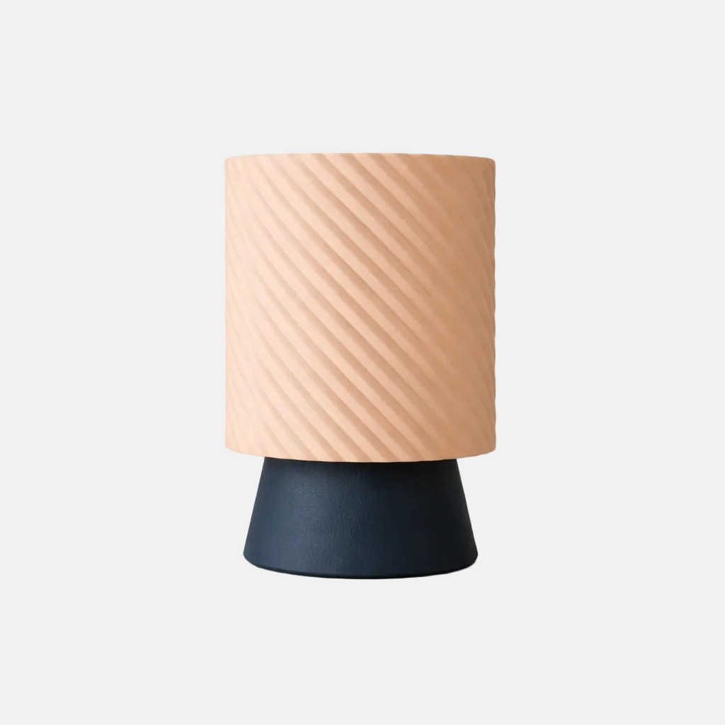 Table lamp with a beige textured shade and navy base on a light gray background