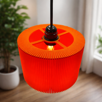 Orange pleated lampshade hanging in a room with plants and curtains.