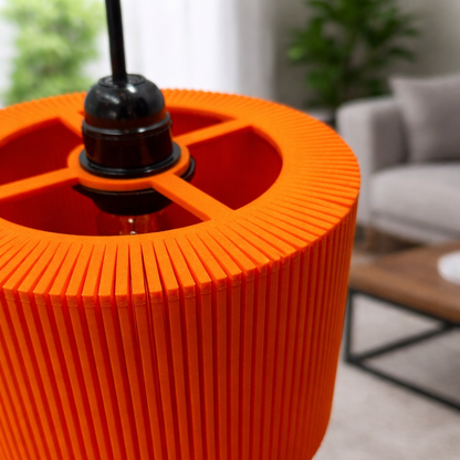 Close-up of an orange textured lamp base with a blurred indoor setting.