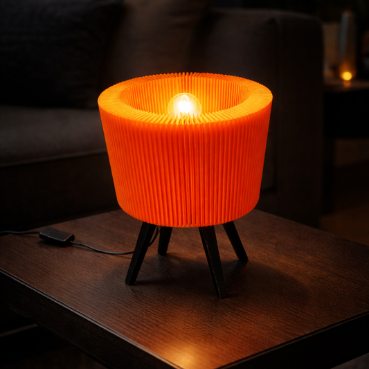 Orange ribbed lamp on a wooden table in a dimly lit room