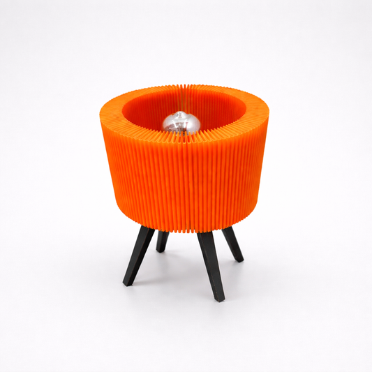 Orange ribbed stool with black legs on a white background