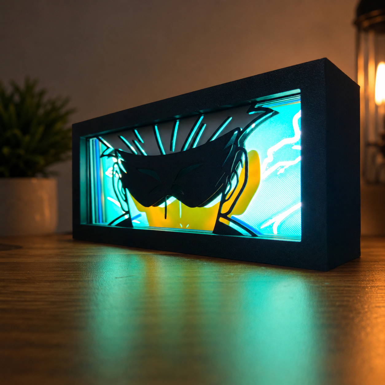 Decorative light box with a silhouette design on a wooden surface.