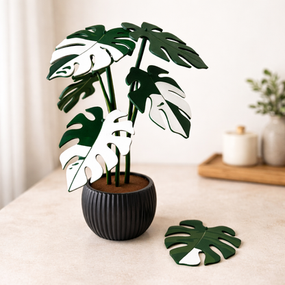 Potted plant with monstera leaves on a table