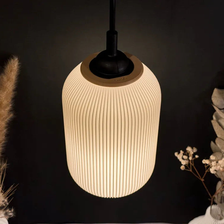Textured pendant light fixture on a dark background with decorative elements