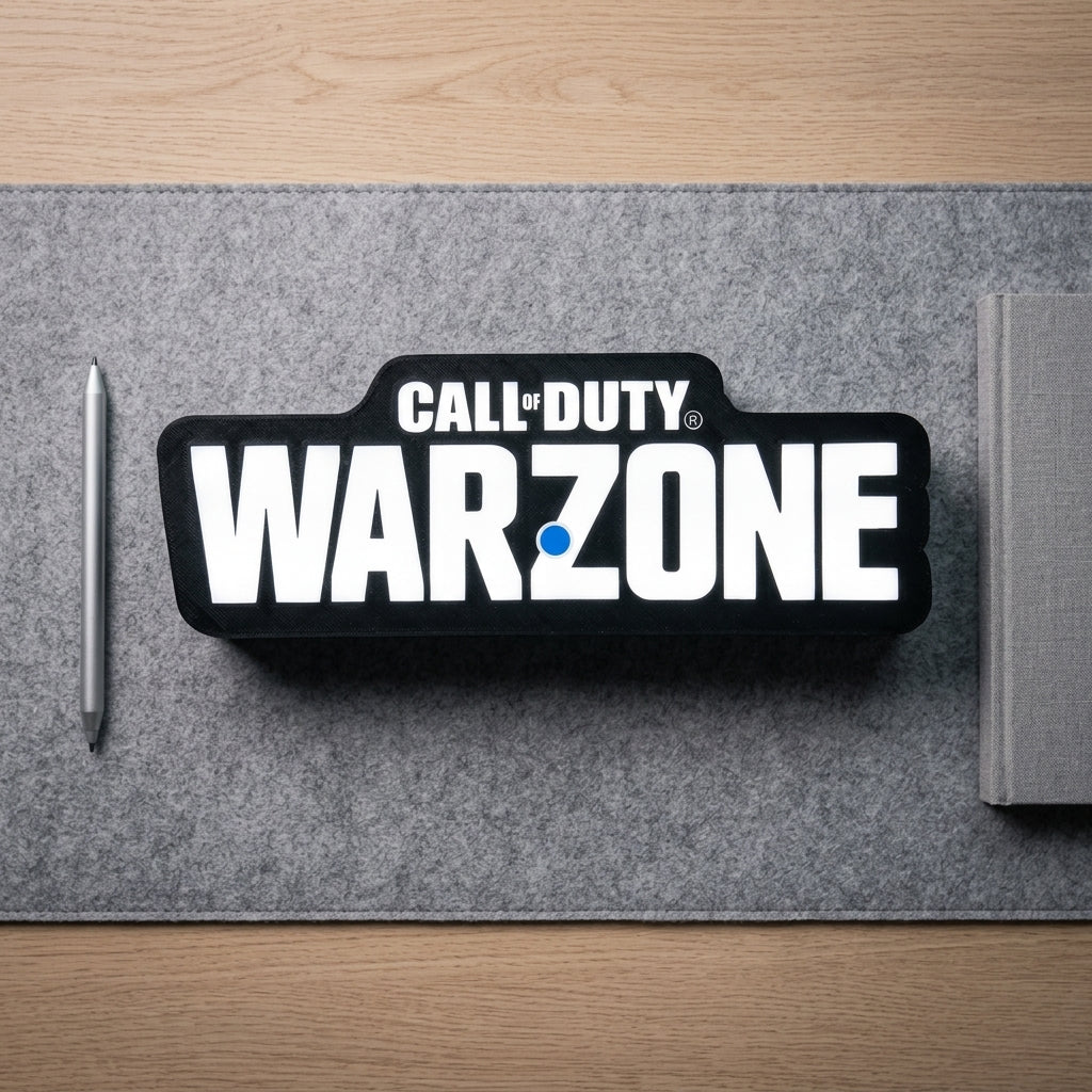 Call of Duty Warzone logo on a desk mat with a pen and notebook.