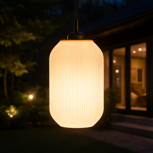 Light fixture hanging outdoors with a blurred house in the background
