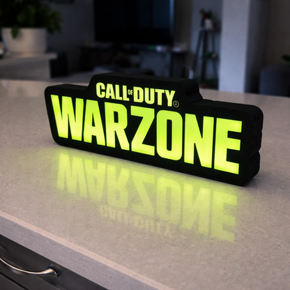 Glowing 'Call of Duty Warzone' sign on a reflective surface