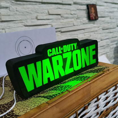 LED sign with 'Call of Duty Warzone' text on a wooden surface.