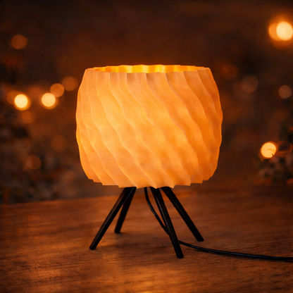 Small lamp with a textured design on a wooden surface, blurred lights in the background