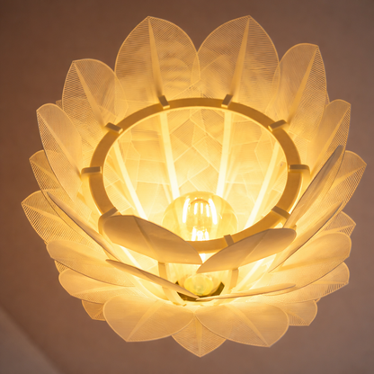 Floral-patterned light fixture with a warm glow on a dark background