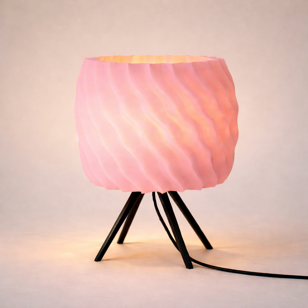Pink textured lamp with black base on a light background
