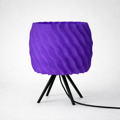 Purple textured lamp with black base on a white background