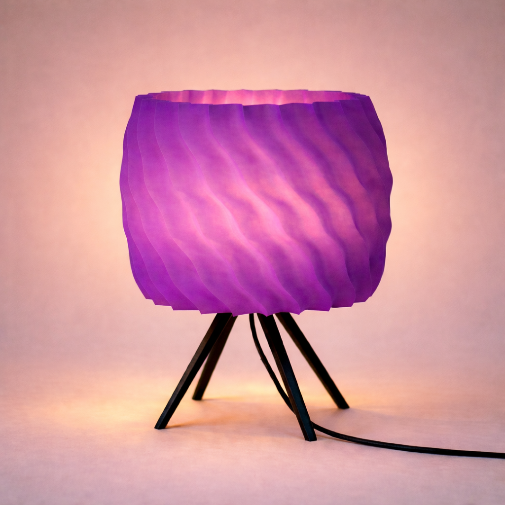 Purple lamp with a wavy texture on a tripod stand against a soft pink background