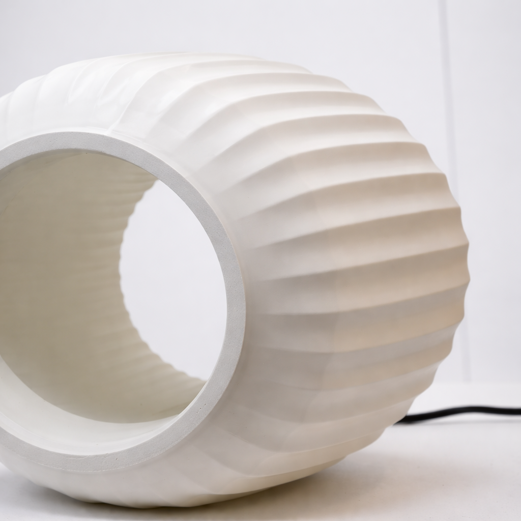 White ribbed cylindrical lamp on a white background