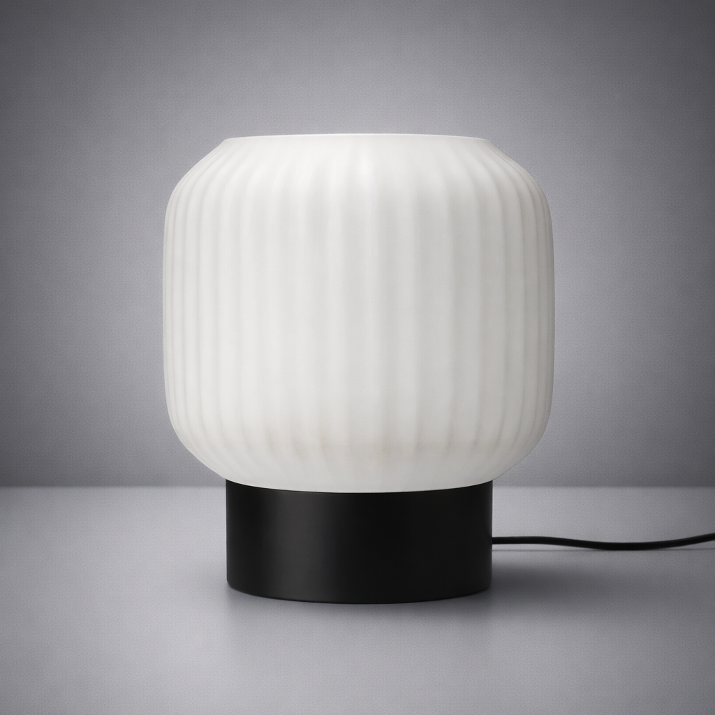 Table lamp with ribbed white shade and black base on a gray background