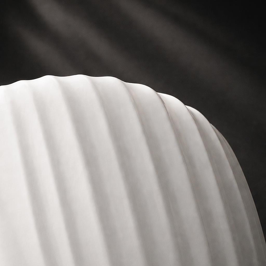 Close-up of a white fabric with folds against a dark background