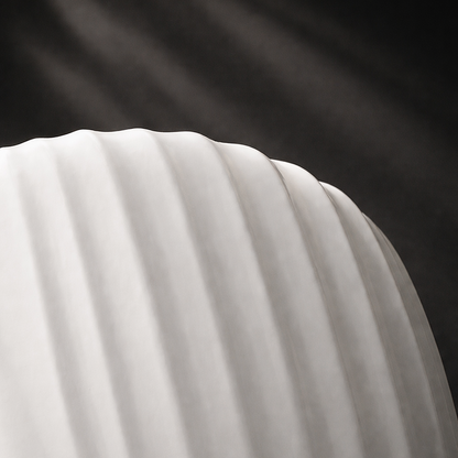 Close-up of a white fabric with folds against a dark background