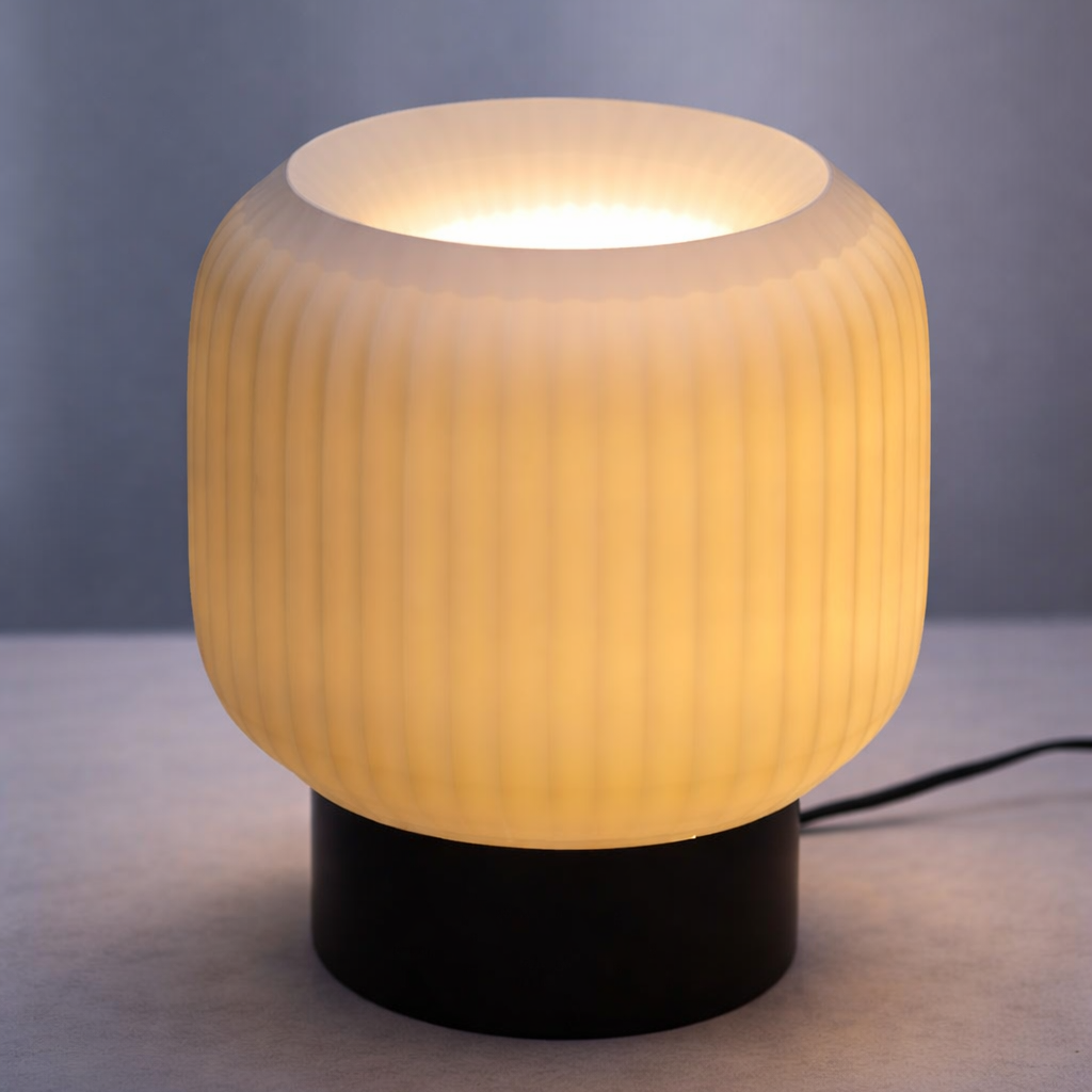 Table lamp with ribbed design and black base on a gray background
